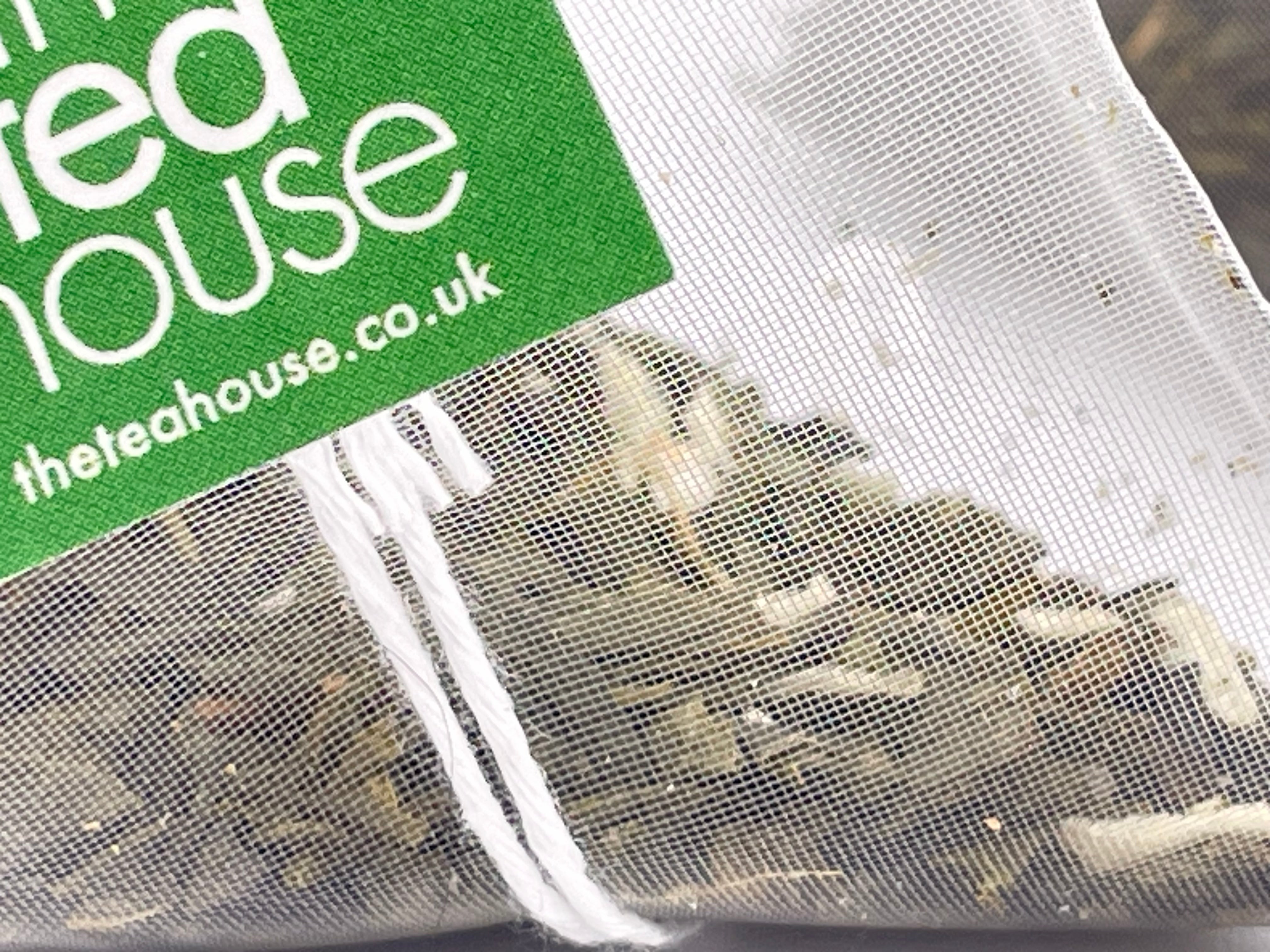 Tea bags with a green label displaying 'theteahouse.pro' on a white background.